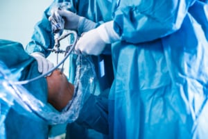 Knee surgery, Orthopedic Operation - two surgeons performing a knee surgery on a patient 
